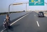 Hai cô gái không đội mũ bảo hiểm phóng xe máy ngược chiều trên làn cao tốc 100 km/giờ