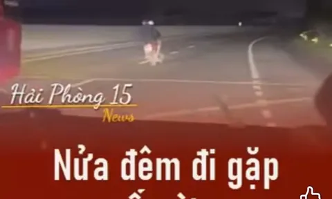 Hai người đàn ông đầu trần, đi xe máy lạng lách, đánh võng trên quốc lộ